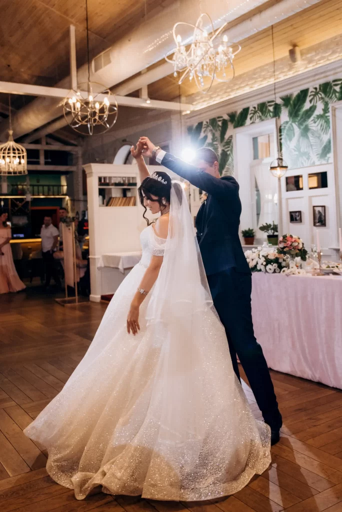 Bride and groom sharing their first dance at a wedding reception, with music provided by the wedding DJ.